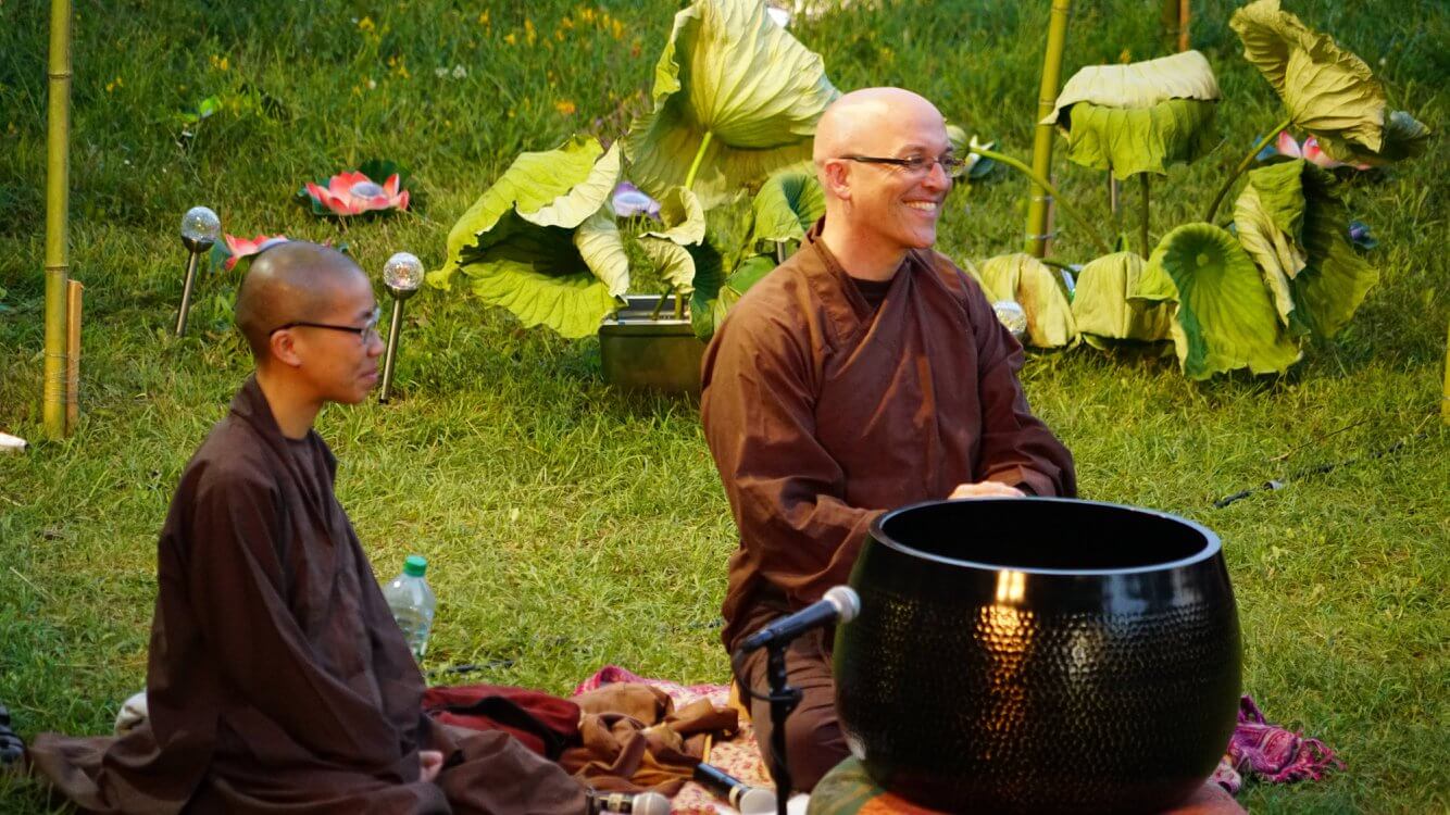 Two monastics with bell